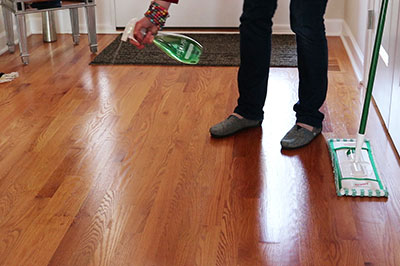 Spray Hardwood Floor Cleaner on to floor
