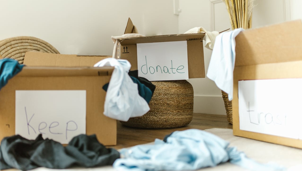 Organizing Home Goods & Clothes in piles to Keep, Donate, or Throw Out